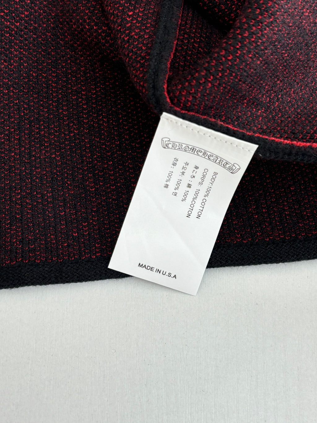 Black long-sleeve top label with care and made in USA text