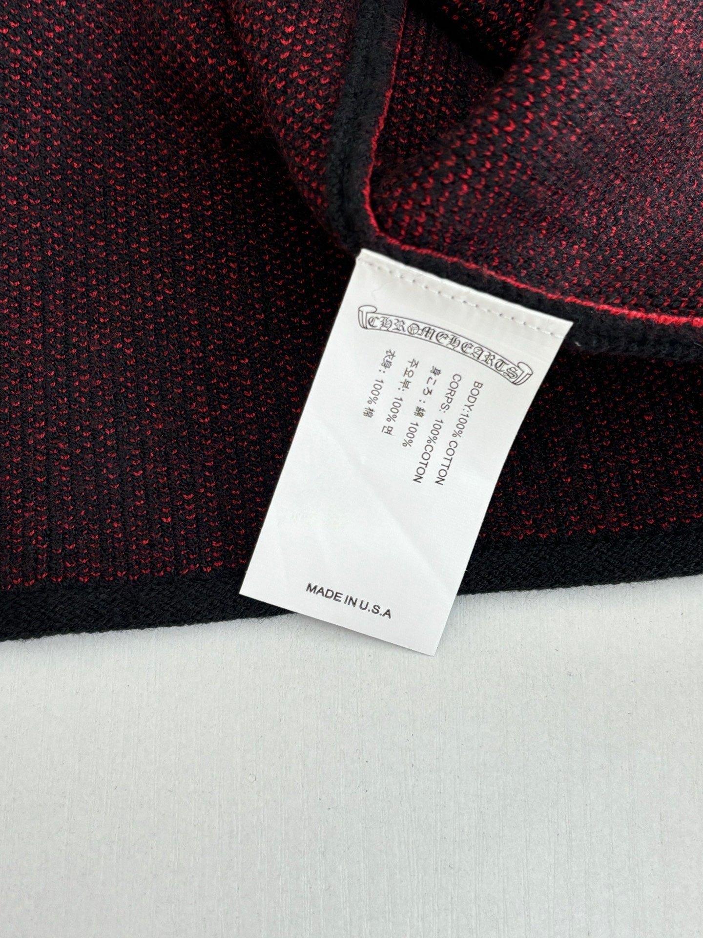 Black long-sleeve top label with care and made in USA text
