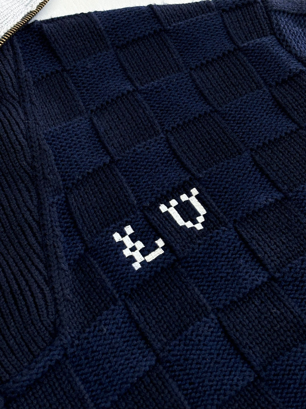 Louis Vuitton navy knit fabric with embossed square pattern and small logo emblem
