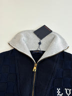 Louis Vuitton navy knit jacket close-up with silver hood trim and gold zipper