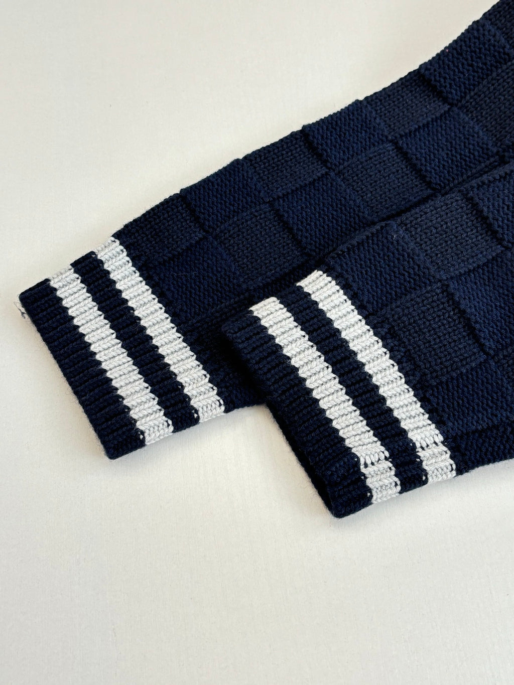 Louis Vuitton navy knit cuff with two white stripe bands and ribbed texture