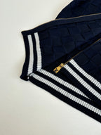 Louis Vuitton navy knit sleeve with striped trim and gold zipper detail