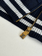 Louis Vuitton navy knit zipper pull with gold hardware and striped trim