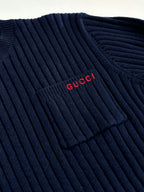 Navy knit sweater with red Gucci logo near shoulder