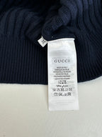 Interior care label on navy knit sweater, Gucci and made in Italy