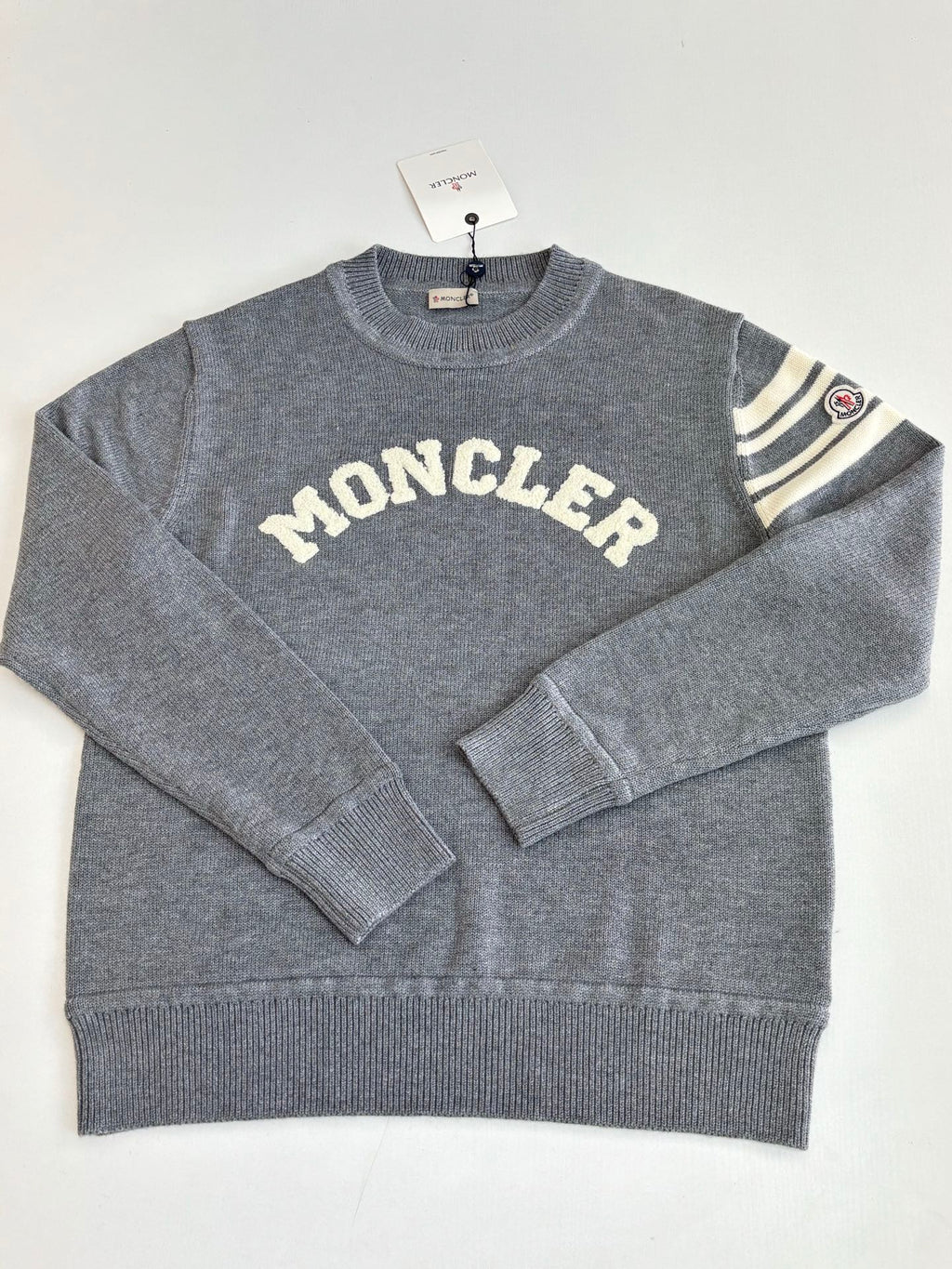 Grey knit crewneck sweater with MONCLER lettering and ribbed hem