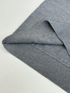 Grey knit sweater ribbed cuff and side seam detail