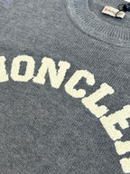 Grey knit sweater showing MONCLER lettering detail