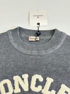 Grey crewneck sweater with MONCLER lettering across the chest