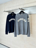 Two long-sleeve crewneck sweaters, grey and navy, with MONCLER logos