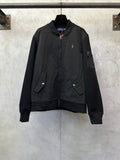 Black zip-up bomber jacket with stand collar, full front zipper, and flap pockets.