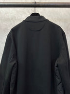 Black zip-up jacket back view with stand collar and smooth upper panel.