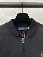 Black jacket collar with Polo Ralph Lauren label and metal zipper pull.