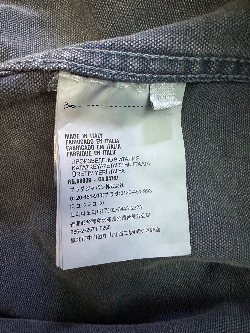 Prada label inside long jacket showing Made in Italy and care text
