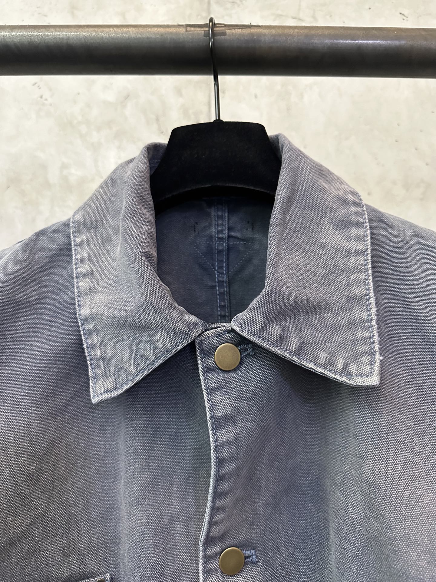 Collared long denim jacket in dark blue-gray with gold-tone buttons at front