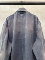 Long denim jacket back view with raised collar and central button placket