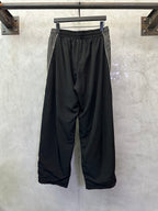 Black Balenciaga pants with gathered waist and oversized wide-leg silhouette