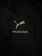 Balenciaga logo embroidery on black pants with cat icon and text