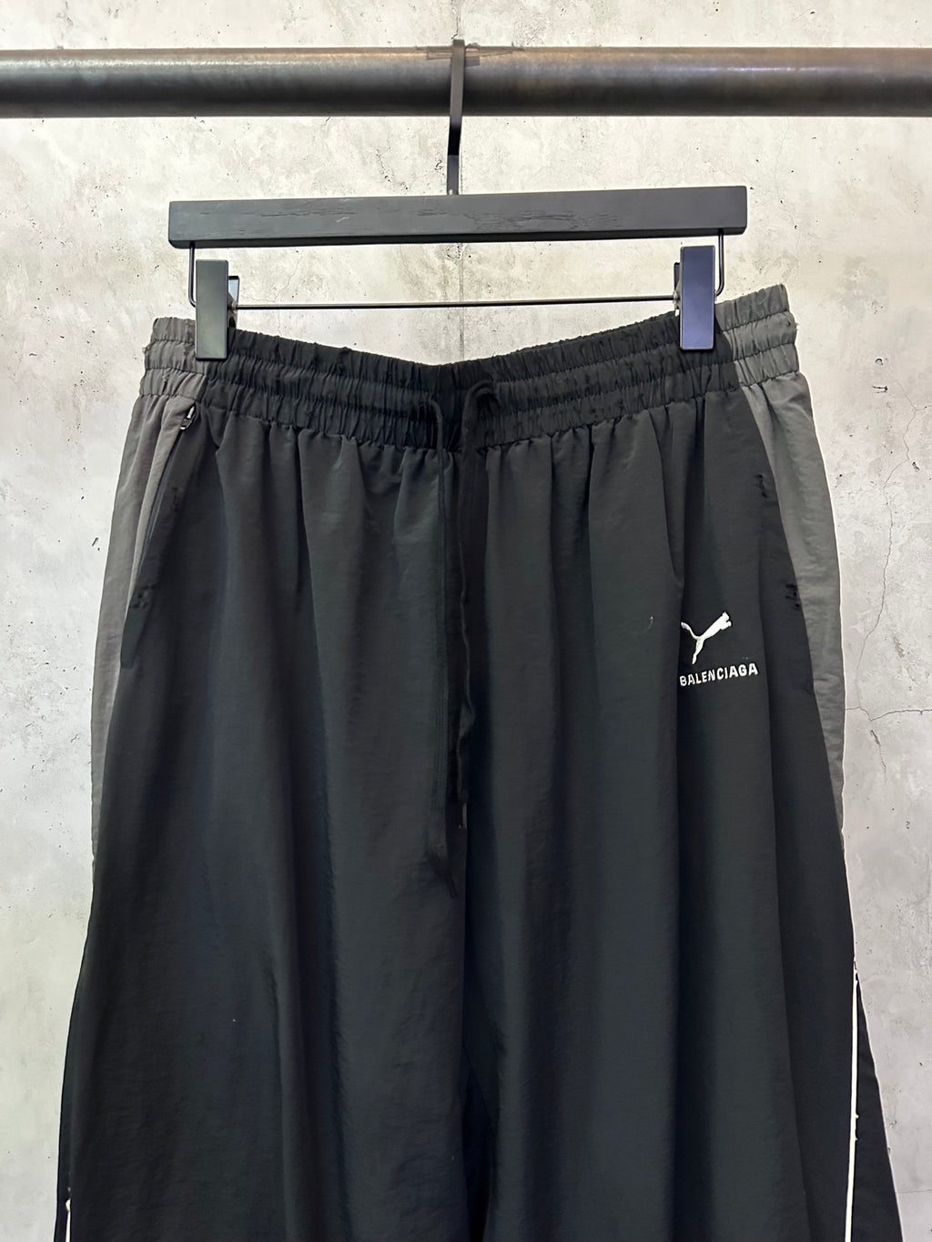 Black Balenciaga pants with elastic waistband and side logo print