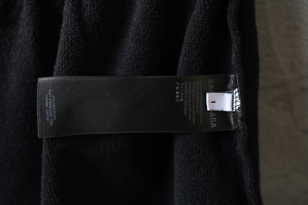 Balenciaga dark shorts with interior label strip near the side seam