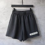 Balenciaga dark charcoal pants with elastic waistband and logo patch hem