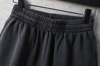 Balenciaga dark shorts with pleated front and elastic waistband