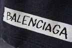 Balenciaga logo patch on dark shorts waistband