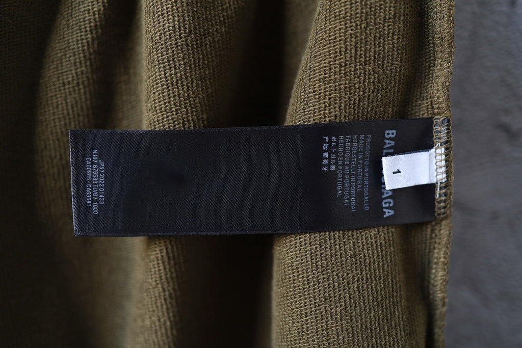 Olive shorts with Balenciaga brand label and inner care tag