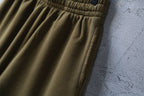Olive shorts with stitched side seam and pleated fabric detail