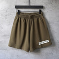 Olive elastic-waist shorts with pleated front and straight hem