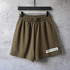 Olive elastic-waist shorts with pleated front and straight hem