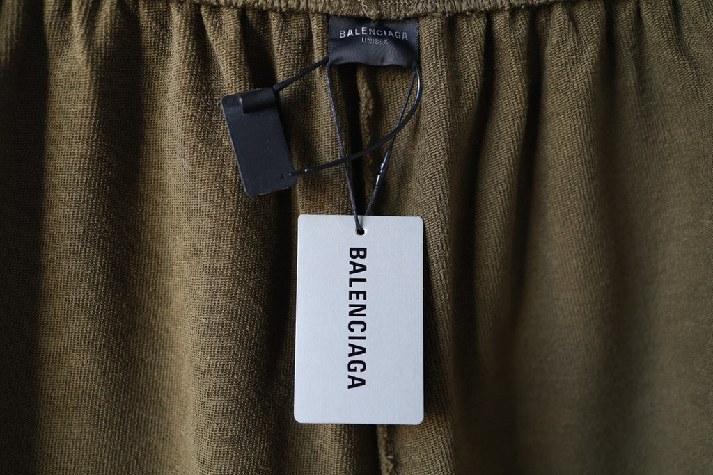 Olive shorts with Balenciaga hang tag attached at the waist