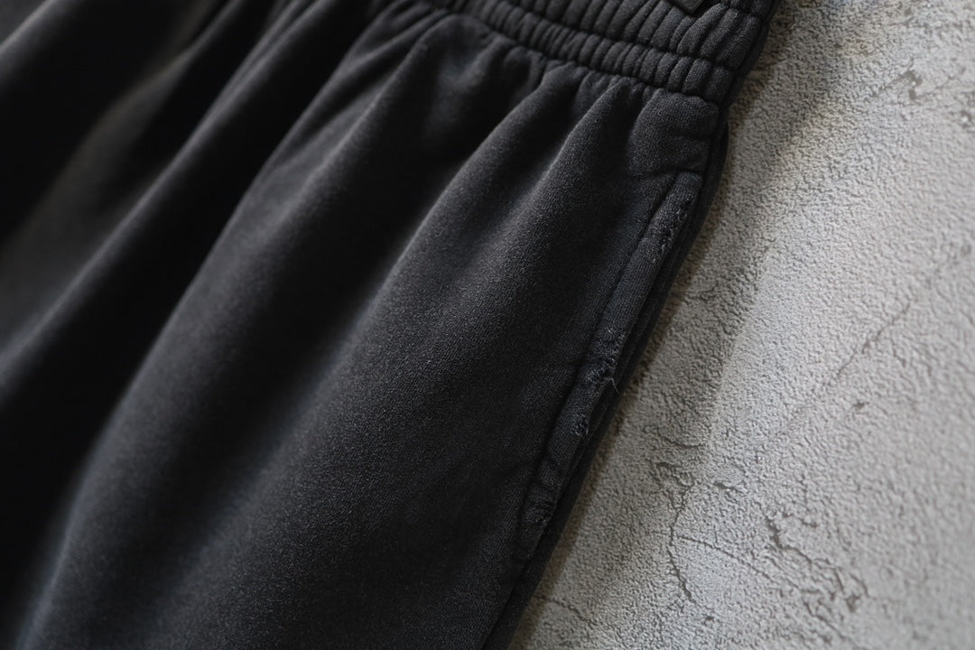 Balenciaga dark shorts showing side seam and gathered fabric at the waistband