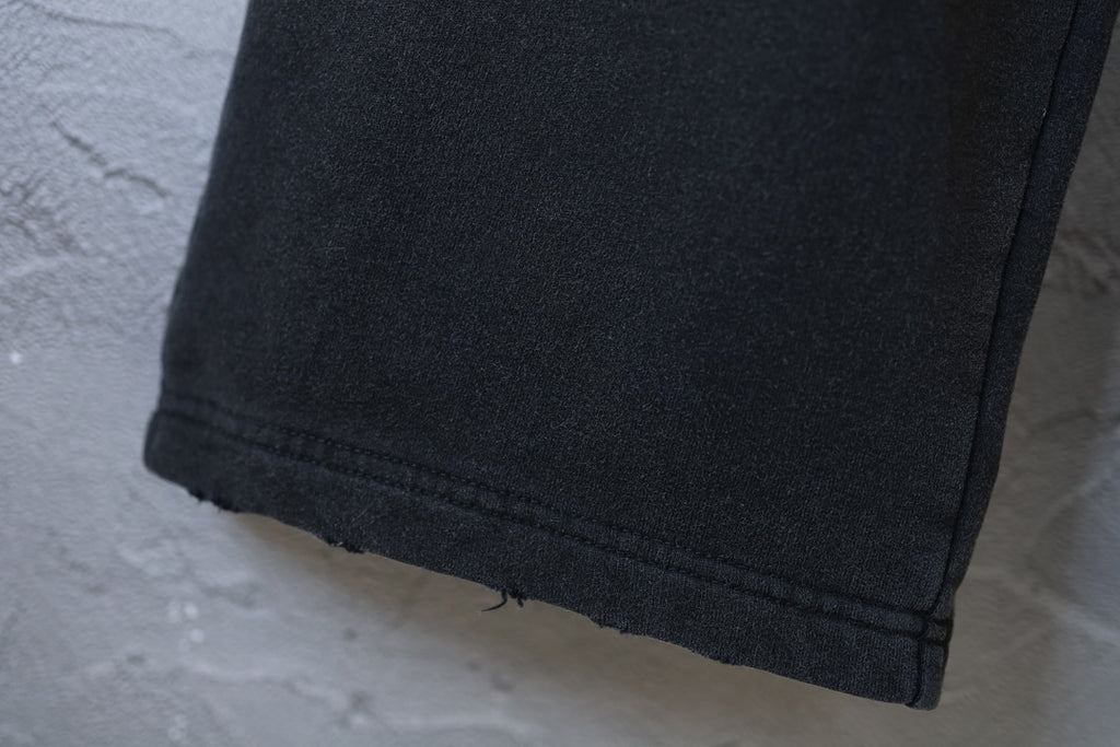 Black pants hem with stitched cuff edge
