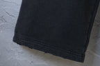 Black pants hem with stitched cuff edge