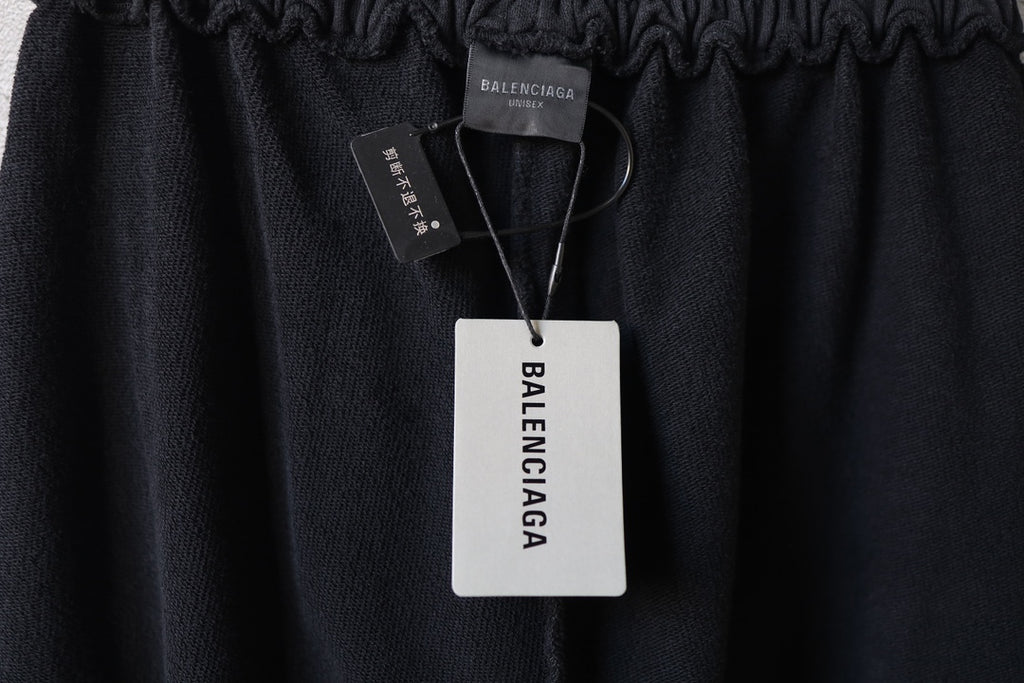 Black pants waistband with hang tag and Balenciaga logo patch