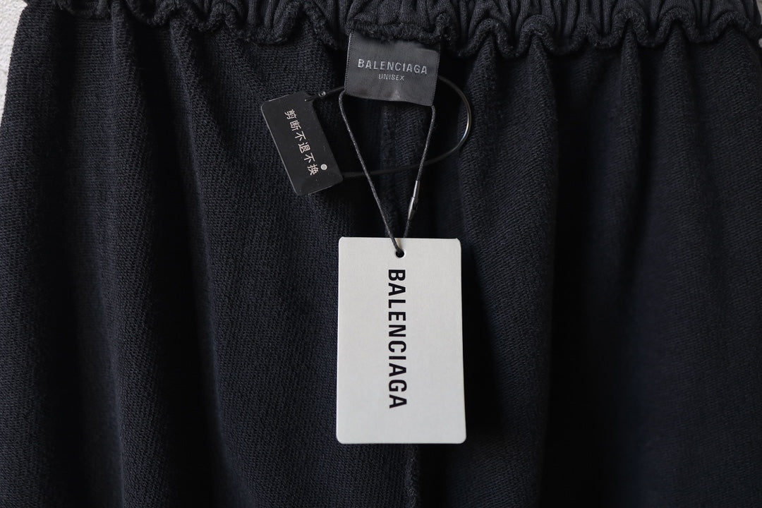 Black pants waistband with attached Balenciaga hang tag