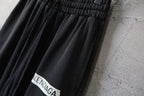 Pleated front pants with elastic waistband and Balenciaga logo patch