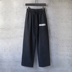 Balenciaga black wide-leg pants with elastic waistband and front logo patch