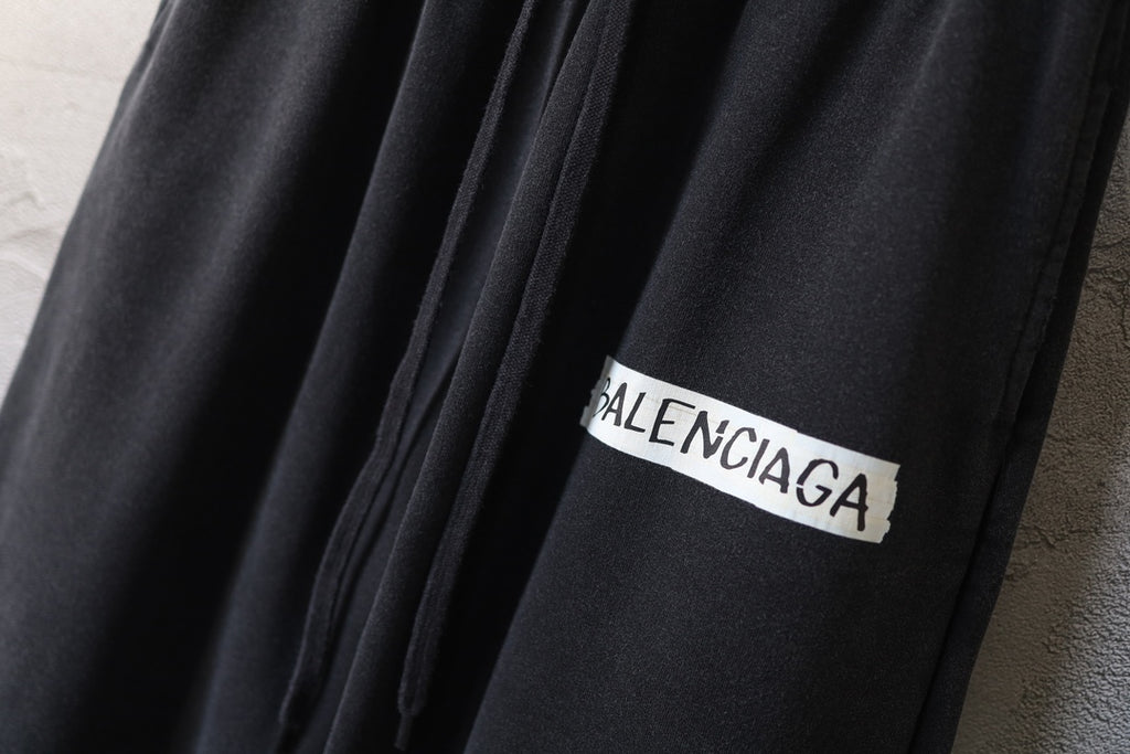 Balenciaga logo patch on black wide-leg pants