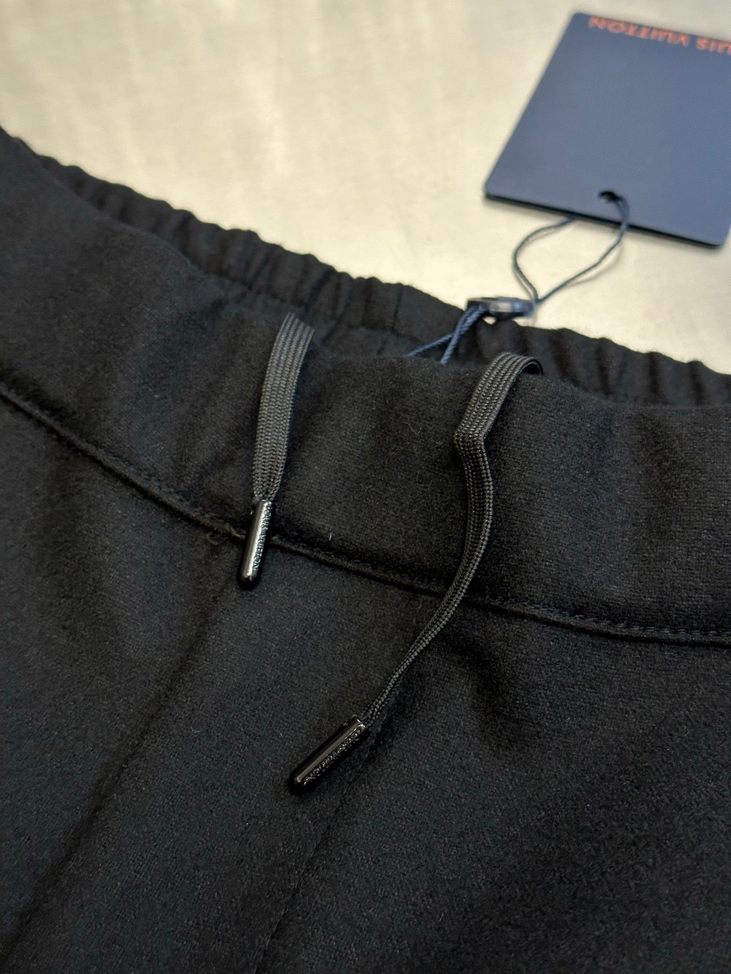 Louis Vuitton dark pants front with drawstring and metal zipper detail