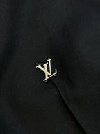 Louis Vuitton dark pants with gold LV logo on side