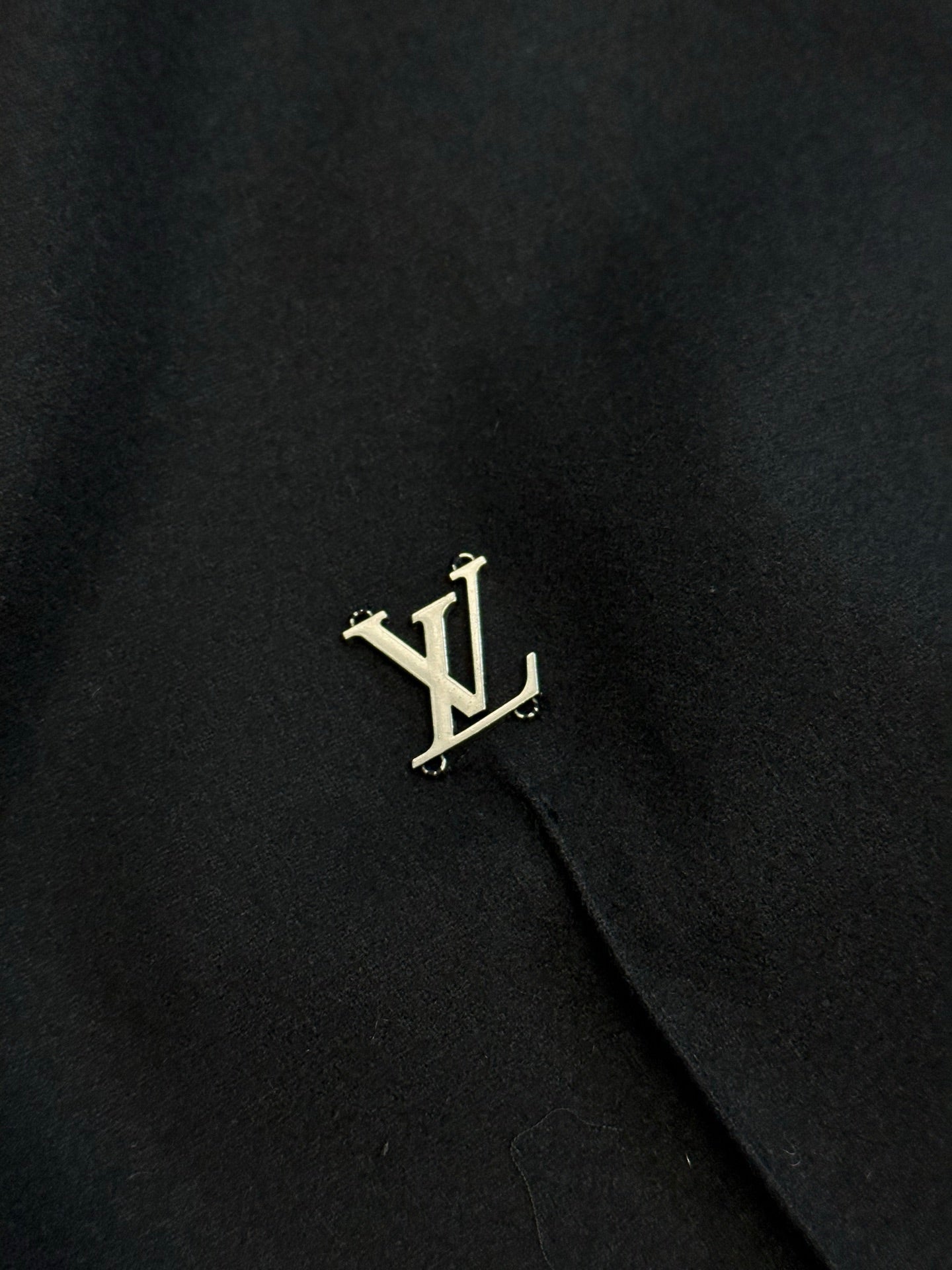 Louis Vuitton dark pants with gold LV logo on side
