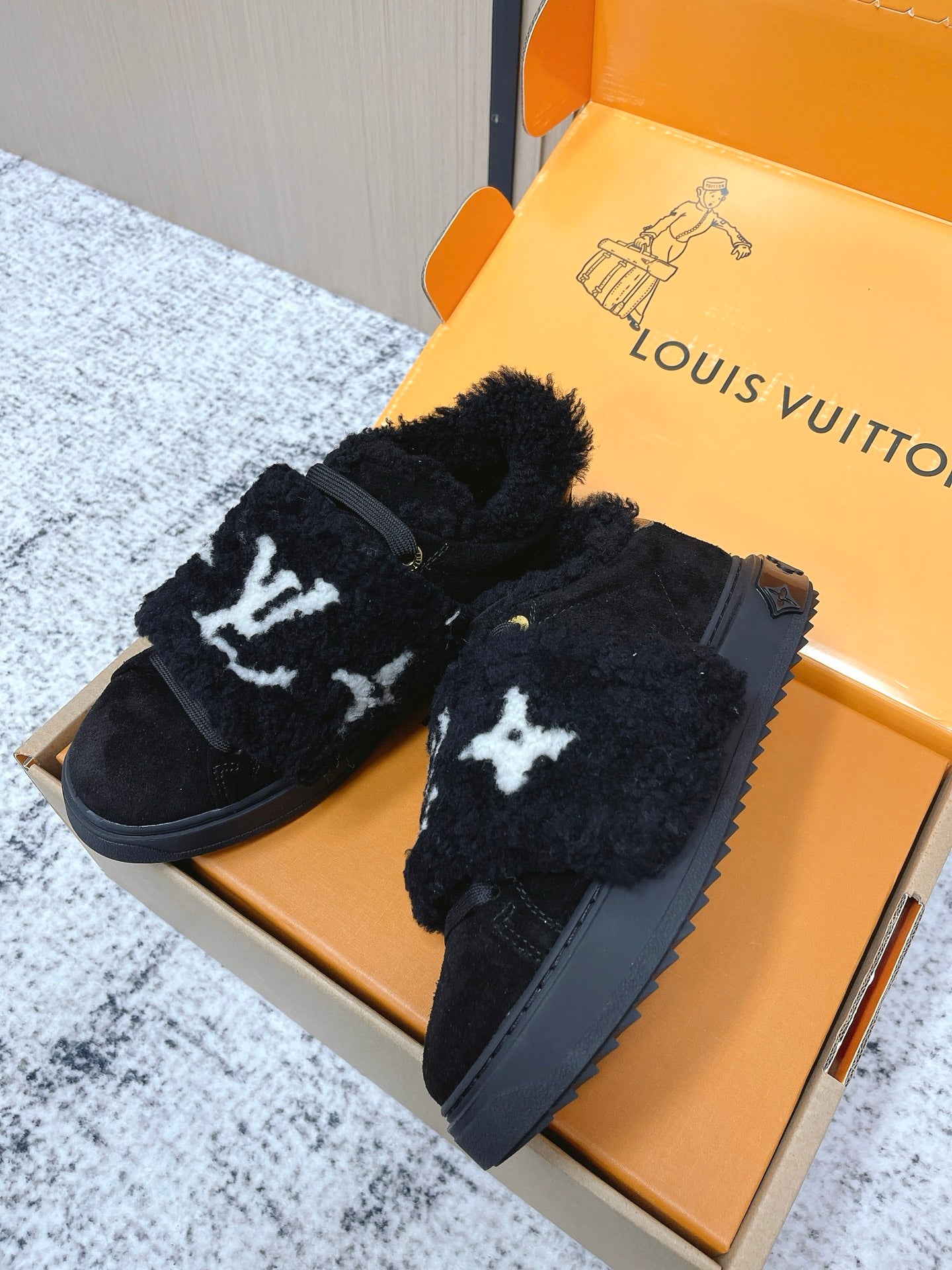 Louis Vuitton black plush slip-on sneakers with white star print, side angle