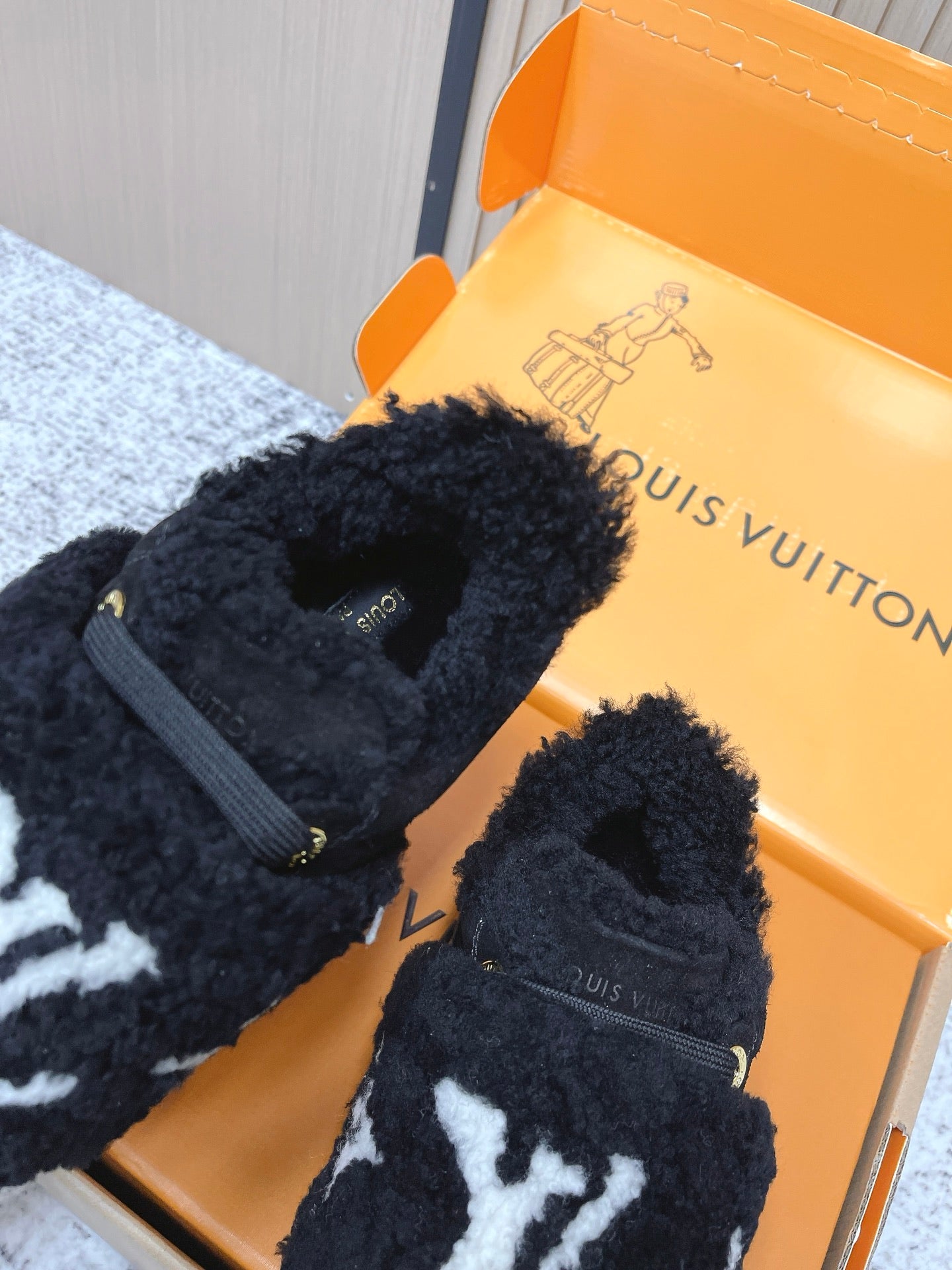 Louis Vuitton black plush slip-on sneakers with white star print and strap detail
