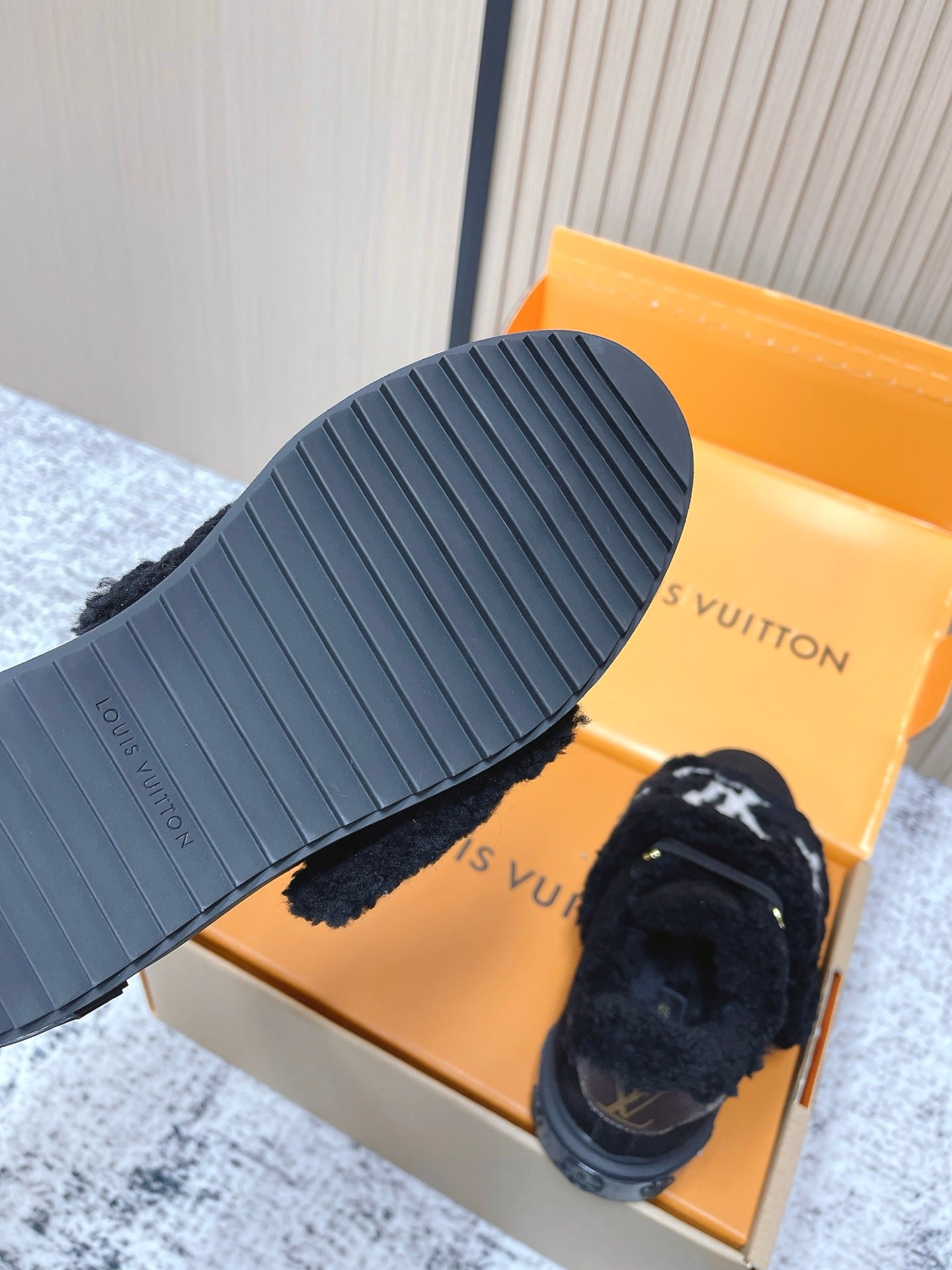 Louis Vuitton black plush slip-on sneaker with ribbed outsole and white star logo