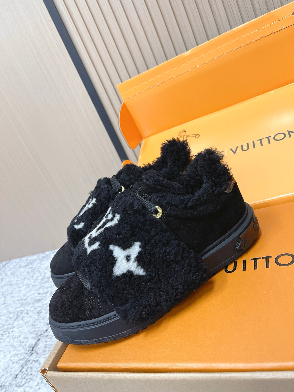 Louis Vuitton black plush slip-on sneakers with white star logo and gold eyelet