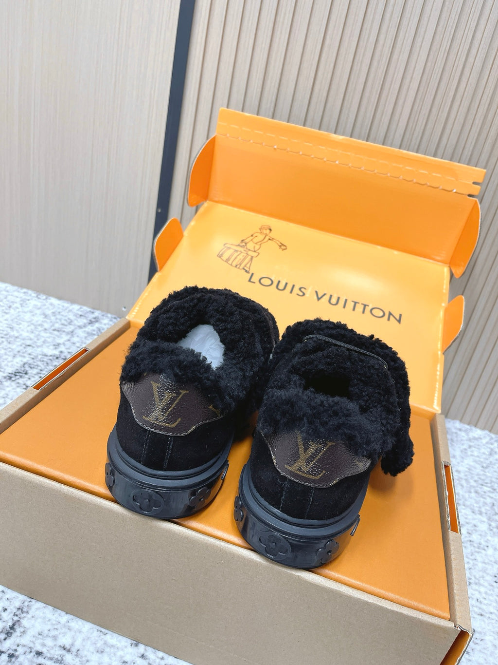Louis Vuitton black plush slip-on sneakers with logo on heel, back view