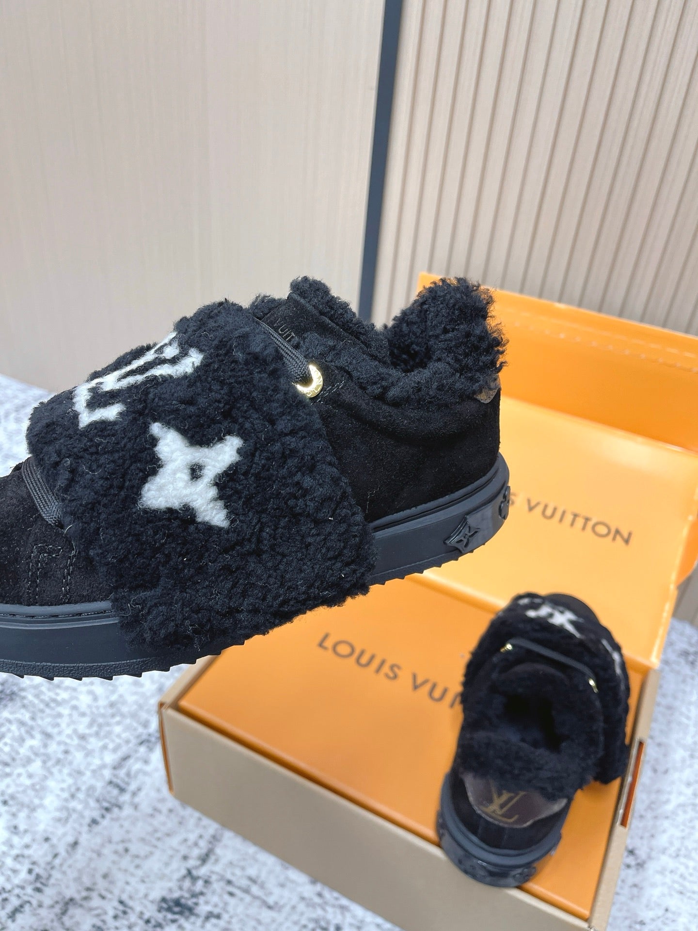 Louis Vuitton black plush slip-on sneakers with white star logo, front close-up