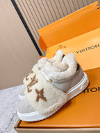 Shearling slip-on sneakers, light gray with tan monogram, side view in box